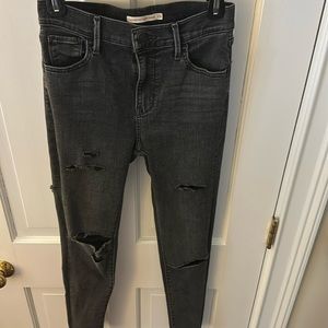 Very distressed Levi black jeans.